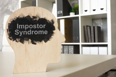 Office and a model of head with phrase impostor syndrome. clipart