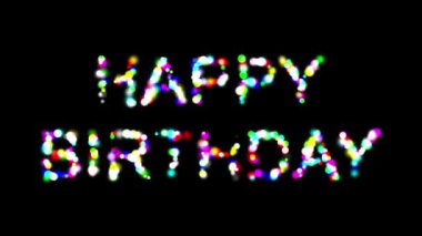 Sade siyah arkaplanda renkli bokeh parçacıkları olan Mutlu Yıllar metni