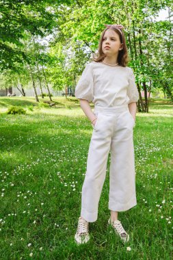 Güneşli ve güzel bir günde kız şehir parkında tek başına vakit geçiriyor. Yalnız zaman geçirmek ve doğada özgürlüğün tadını çıkarmak. Huzurlu atmosfer.