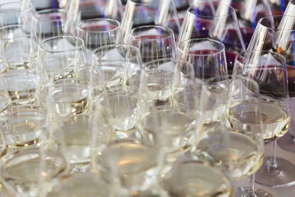 Glasses with white wine. Catering services. Glasses with wine in row background at restaurant party. Shallow dof.