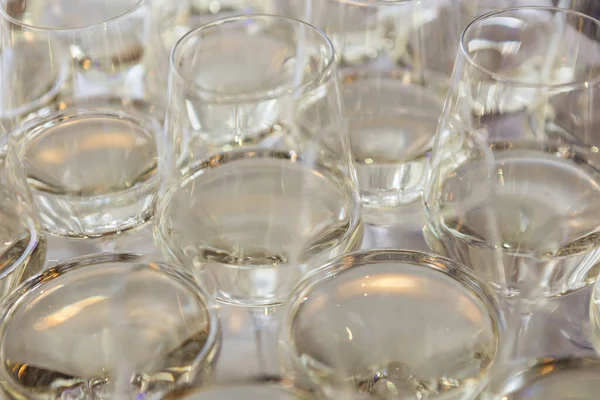 Glasses with white wine. Catering services. Glasses with wine in row background at restaurant party. Shallow dof.