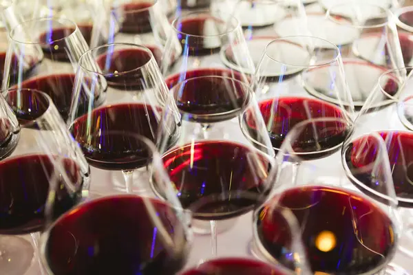 Glasses with red wine. Catering services. glasses with wine in row background at restaurant party. Shallow dof
