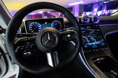 Kyiv, Ukraine - September 12: Mercedes-Benz luxury car interior showcasing the sleek design of the steering wheel, digital dashboard, and advanced navigation system clipart