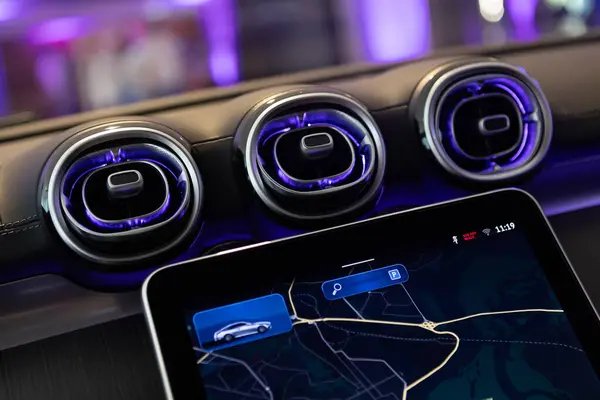 stock image Close-up of a luxury cars interior dashboard, showcasing advanced technology and design with stylish air vents.