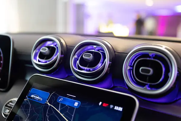 stock image Close-up of a luxury cars interior dashboard, showcasing advanced technology and design with stylish air vents.