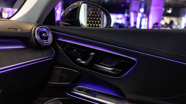 Luxury car interior featuring ambient lighting, sleek design, and premium materials