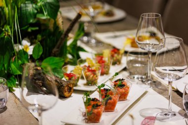 Exquisite gourmet salmon tartare appetizers elegantly presented in clear cups, garnished with black caviar and fresh microgreens, ideal for luxury events, cocktail parties, and high-end catering.