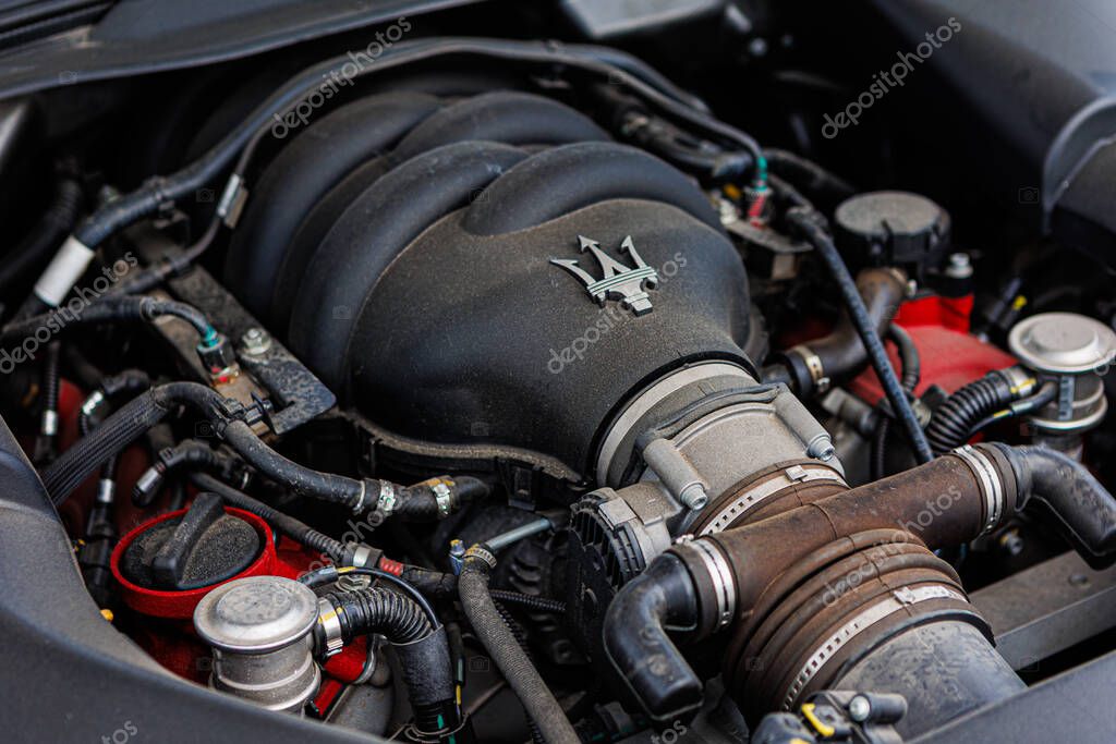 Kyiv, Ukraine - June 12, 2025: Powerful Maserati engine, showcasing intricate mechanical details and the iconic trident logo on the engine cover. Italclub gathering in Kyiv.