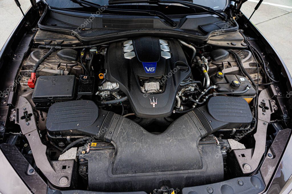 Kyiv, Ukraine - June 12, 2025: Powerful Maserati engine, showcasing intricate mechanical details and the iconic trident logo on the engine cover. Italclub gathering in Kyiv.