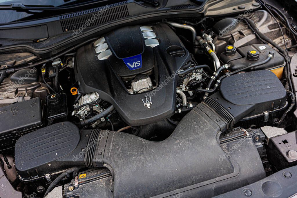 Kyiv, Ukraine - June 12, 2025: Powerful Maserati engine, showcasing intricate mechanical details and the iconic trident logo on the engine cover. Italclub gathering in Kyiv.