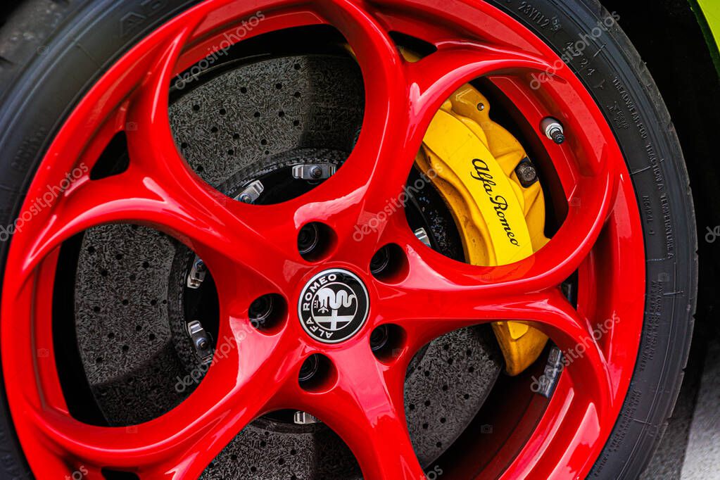 Kyiv, Ukraine - June 12, 2025: A dynamic close-up of a high-performance wheel, showcasing a vibrant color contrast between the red rim and yellow brake caliper. This image captures the essence of speed, precision engineering, and bold Italian design.