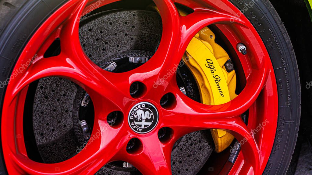 Kyiv, Ukraine - June 12, 2025: A dynamic close-up of a high-performance wheel, showcasing a vibrant color contrast between the red rim and yellow brake caliper. This image captures the essence of speed, precision engineering, and bold Italian design.