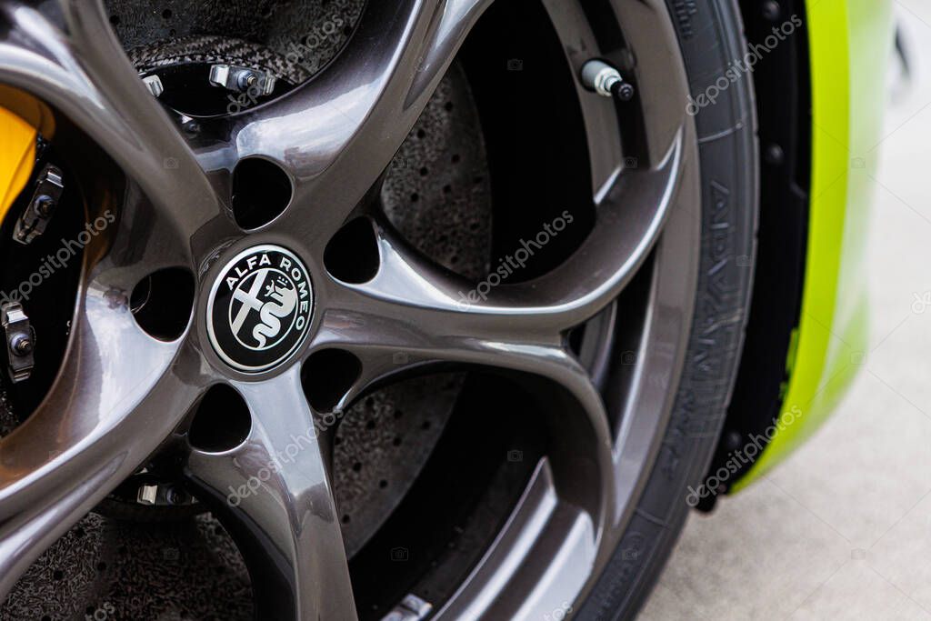 Kyiv, Ukraine - June 12, 2025: Close-up of a stylish grey alloy wheel featuring the iconic Alfa Romeo logo, embodying Italian luxury, precision engineering, and automotive passion. Ideal for concepts of heritage, performance, sophisticated design, an