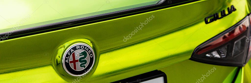 Kyiv, Ukraine - June 12, 2025: A vibrant, close-up view of the rear of an Alfa Romeo Giulia in a striking metallic green, showcasing the iconic badge and sleek design. Perfect for conceptual themes of luxury, innovation, dynamic performance, and forw