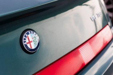 Kyiv, Ukraine - June 12, 2025: Alfa Romeo emblem on a sleek metallic green car body, featuring a glimpse of the red tail light. This image powerfully conveys brand prestige, Italian automotive heritage, and timeless design, perfect for conceptualizin
