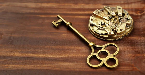 Gold vintage key with clock mechanism, escape room game banner