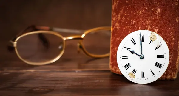 Eyeglasses with old book and clock face. Storytelling, story time background