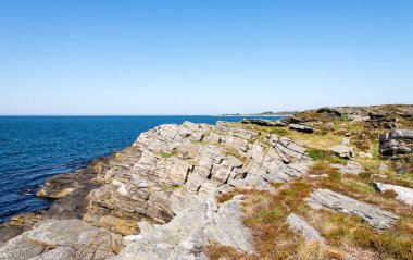 Scenic coastal landscape with geological formation layers in Kvernevik suburb, Stavanger, Norway, May 2018