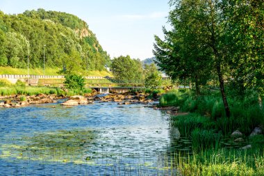 A view to the river and a small dam near Algard town, Norway, June 2018