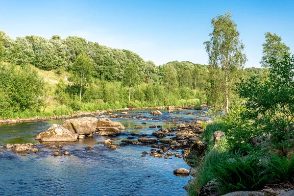 Scenic view of the shallow river rocky ford near Algard town, Norway, June 2018