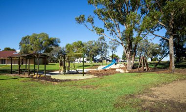 Windermere Park 'taki oyun parkı Parlak Güneşli bir günde ağaçlarla çevrili, Joondalup, Avustralya, Mart 2020