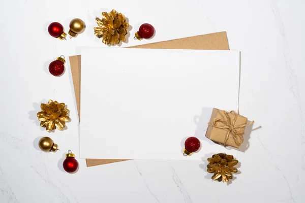 Mockup for a letter or a Christmas invitation with gold fir cone