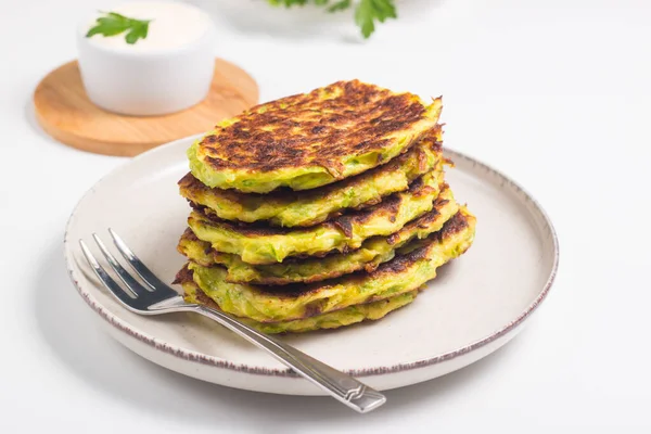 stock image Vegetarian zucchini fritters or courgettes pancakes, served with fresh herbs and sour cream.