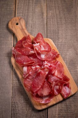Italian slices of coppa, capocollo, capicollo, bresaola or cured ham with rosemary. Raw food