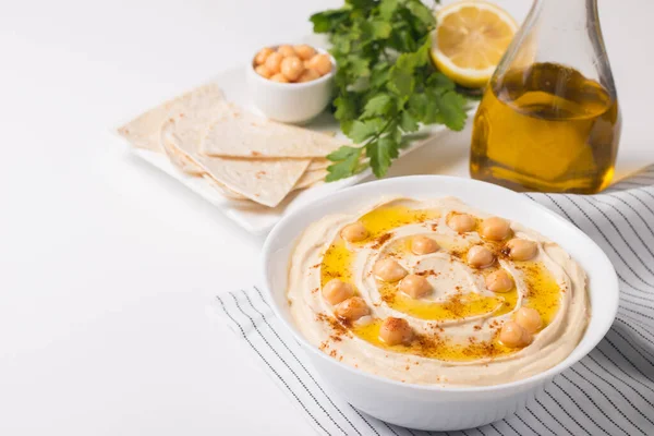 stock image Hummus in a plate with chickpeas, smoked paprika, olive oil and 