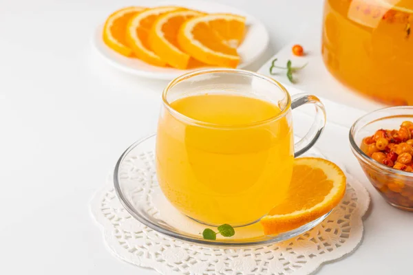 Sea buckthorn tea drink with oranges and mint. Autumn comfort hot drink. Herbal vitamin tea.