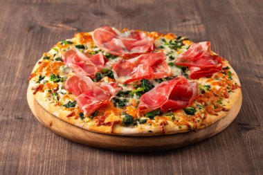 Prosciutto, jambon, roka, ıspanak, domates, pesto, peynir ve parmesanlı pizza. İtalyan mutfağı. 