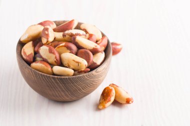 Brazil nuts in a bowl.  clipart