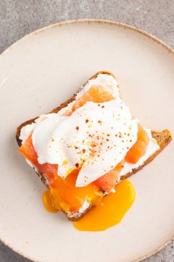 Somon ve peynirli tost üzerine haşlanmış yumurta. Kahvaltı konsepti. Sandviç aç. 
