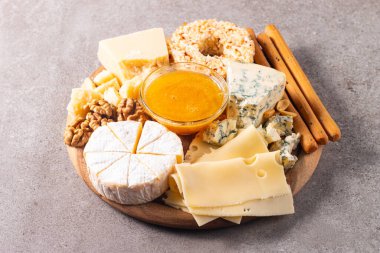 Çeşitli peynirler ve zeytinlerle ahşap tahta. Krem peynir. Camembert peyniri. Parmesan, feta, mavi peynir. İtalyan, Fransız peyniri
