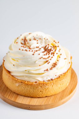 Krem şantili limonlu turtalar, beyaz arka planda çikolata parçaları.