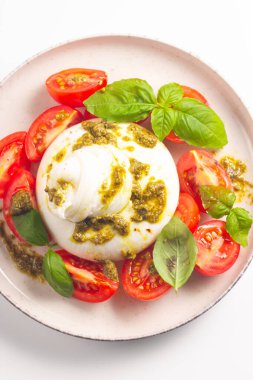 Çeri domatesli Burrata peynirli Caprese salatası, zeytin yağı, pesto ve baharat. Taze gıda konsepti. 