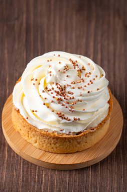 Krem şantili limonlu turtalar, beyaz arka planda çikolata parçaları.