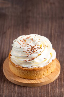 Krem şantili limonlu turtalar, beyaz arka planda çikolata parçaları.