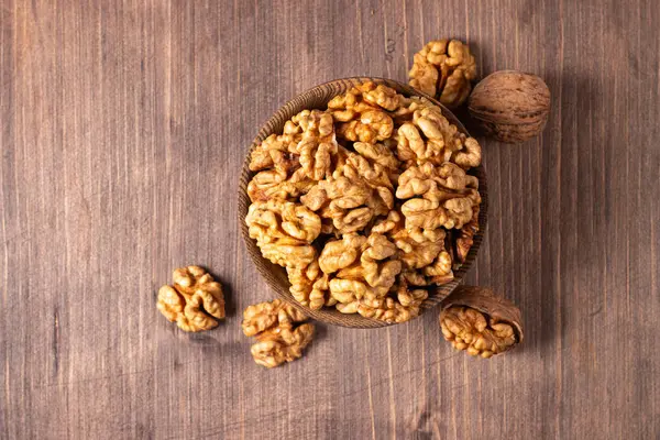 Ahşap arka planda bir kasede ceviz