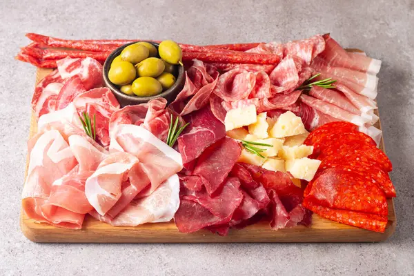 Şarküteri tahtası. Salamlı, jambonlu ve jambonlu et ve peynir tabağı aperatifleri.