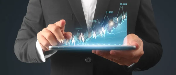 Businessman plan graph growth and increase of chart positive indicators in his business,tablet in hand