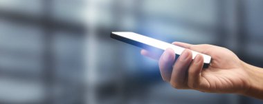 Hand holding smartphone device touching screen