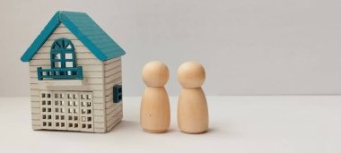 Çift birlikte ev planlaması yapıyor. Ev içinde rahat. Ahşap heykelcikler, minimalist tasarım aile kavramı.