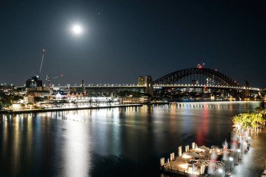 Full moon lighting up Circular Quay and the Harbour bridge in Sydney, Australia