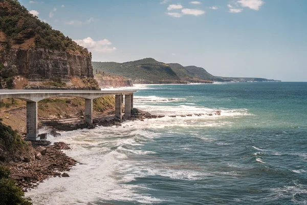 Sea Cliff Bridge, a balanced cantilever bridge built in 2005, curves around the coast of New South Wales in Australia connecting the towns of Clifton and Coalcliff