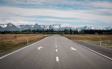 View along the Fairlie to Tekapo road towards the snow capped peaks of Mount Cook National Park