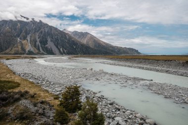 Hooker River flowing towards the Tasman River near Mount Cook in the South Island of New Zealand with mountains in the background