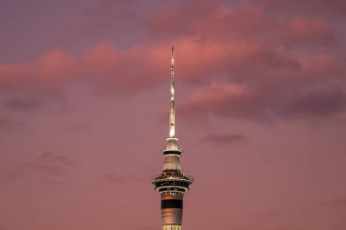 Auckland, New Zealand - December 27th 2022: Dusk falling over Sky Tower, a 328m tall telecommunications and observation tower in Auckland, New Zealand