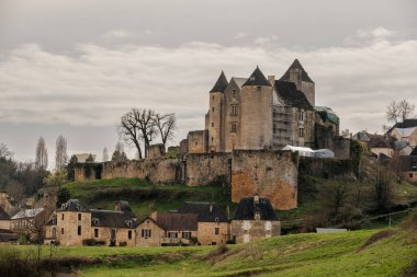Salignac-Eyvigues, Nouvelle-Aquitaine, France - 17th March 2024: Chateau de Salignac in the village of Salignac-Eyviguesin the Dordogne region of France originally dates back as far as the 11th century clipart