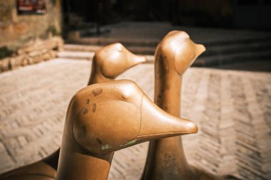 Sarlat-la-Caneda, Nouvelle-Aquitaine, France - 4th April 2024: Statue de trois Oies, a bronze statue of three geese, by Francois-Xavier Lalanne in Sarlat-la-Caneda in the Dordogne region of France clipart